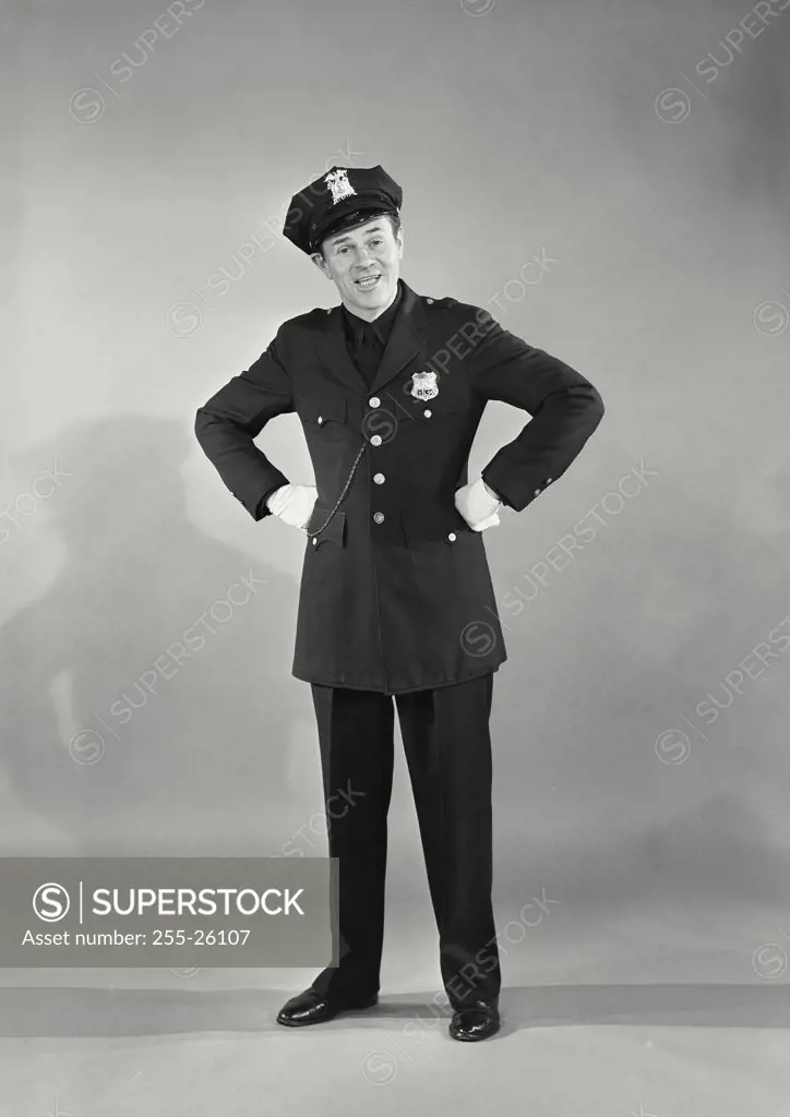 Vintage photograph. Full length portrait of policeman with hands on hips