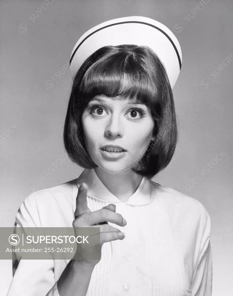 Portrait of a female nurse pointing with her finger