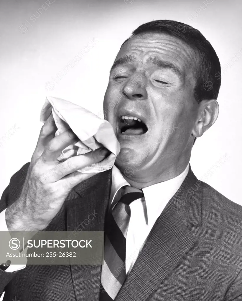 Close-up of a mature man sneezing