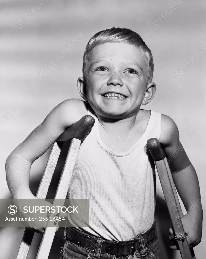 Close-up of a boy standing on crutches