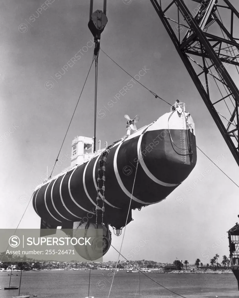 Low angle view of a submarine being lowered in a sea, Bathyscaphe Trieste