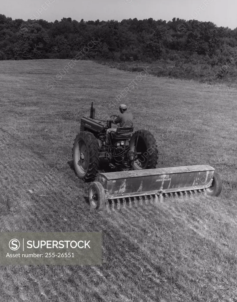 Farmer fertilizing the crop with a tractor