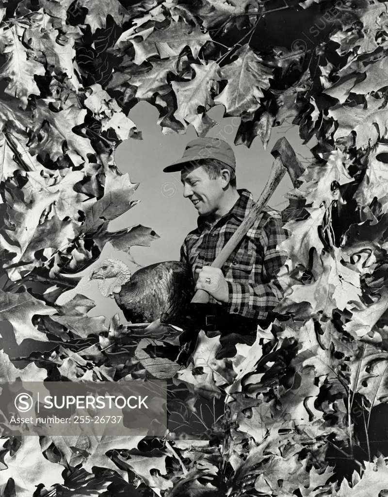 Vintage photograph. Side profile of a young man holding ax and turkey