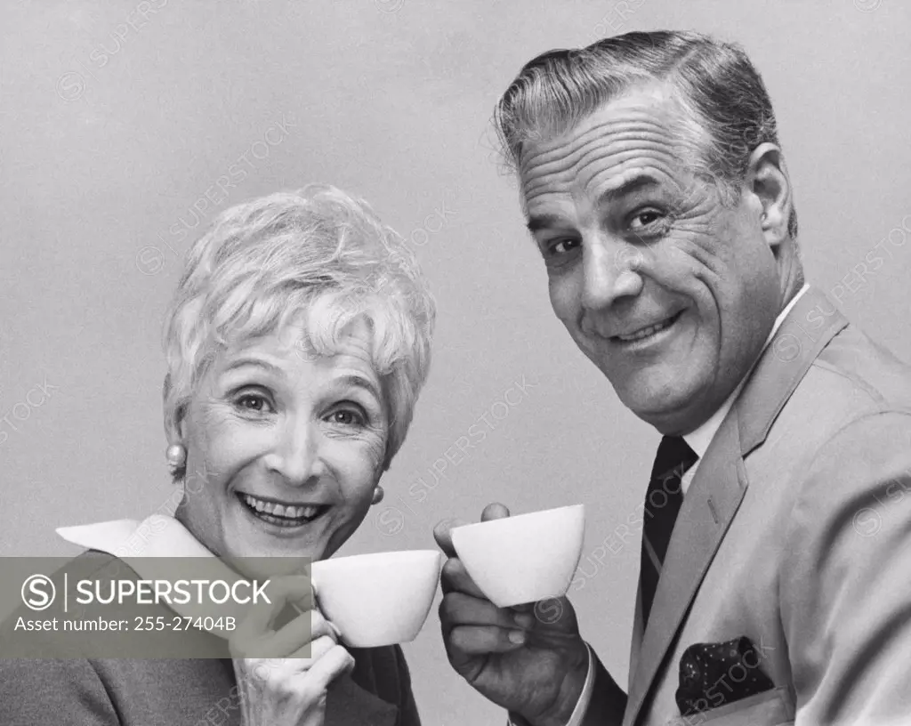 Portrait of a senior couple holding tea cups and smiling