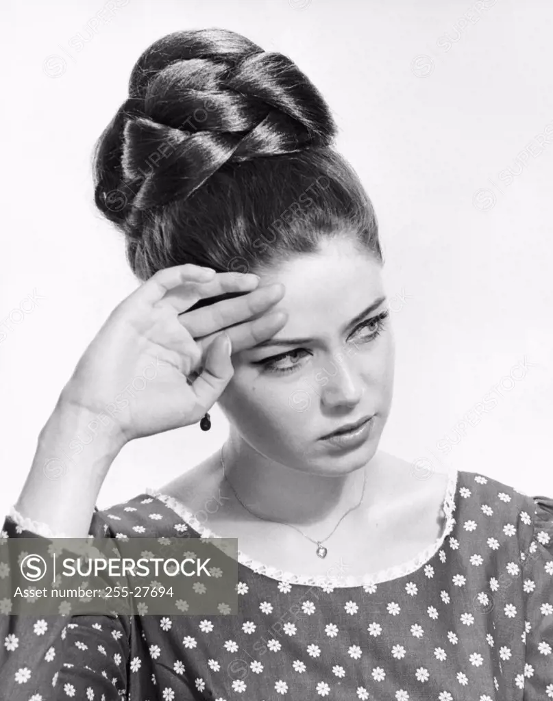Close-up of a young woman suffering from a headache