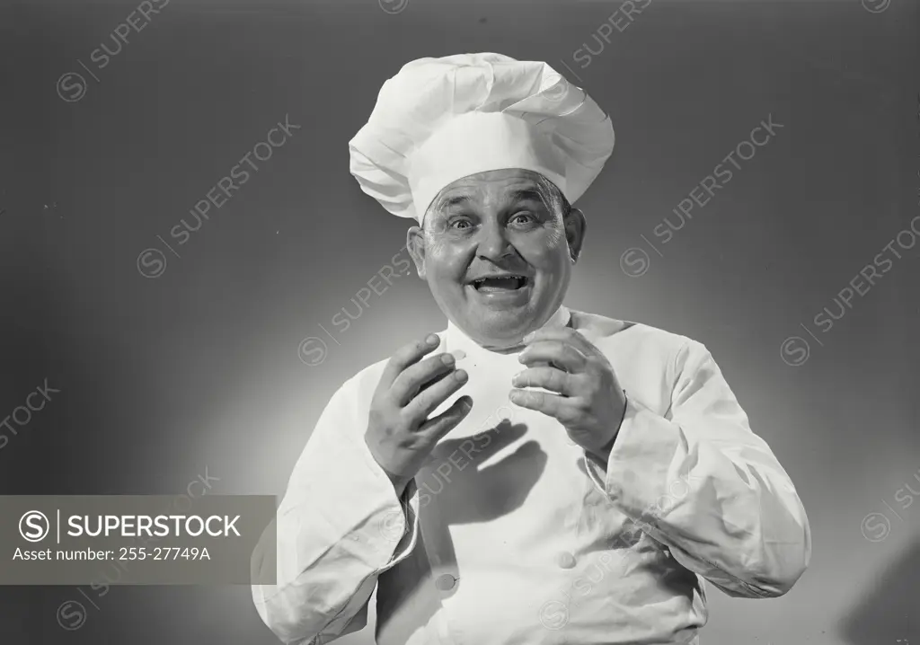 Vintage Photograph. Man in chefs uniform smiling with arms up