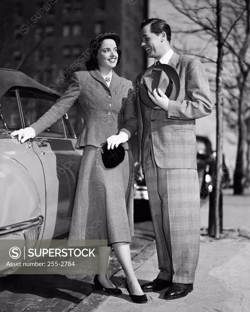 Young couple standing near a car