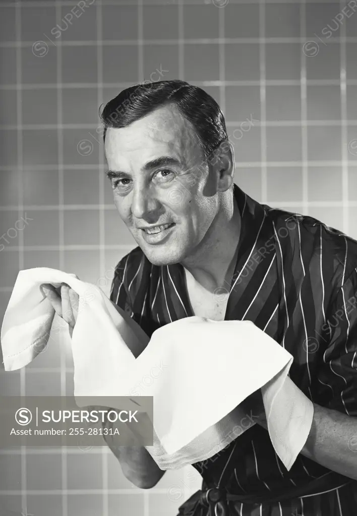 Vintage photograph. Man in robe washing face