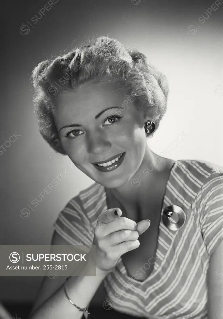 Vintage photograph. Woman in striped deep neck blouse smiling at camera