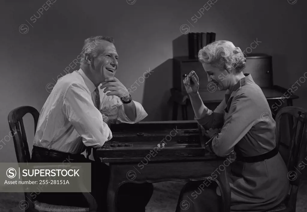 Man and woman playing board game