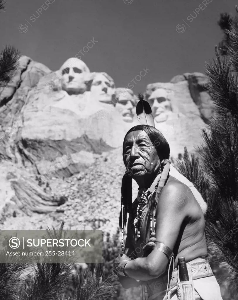 Sioux man standing in front of a memorial, Mount Rushmore National Memorial, South Dakota, USA
