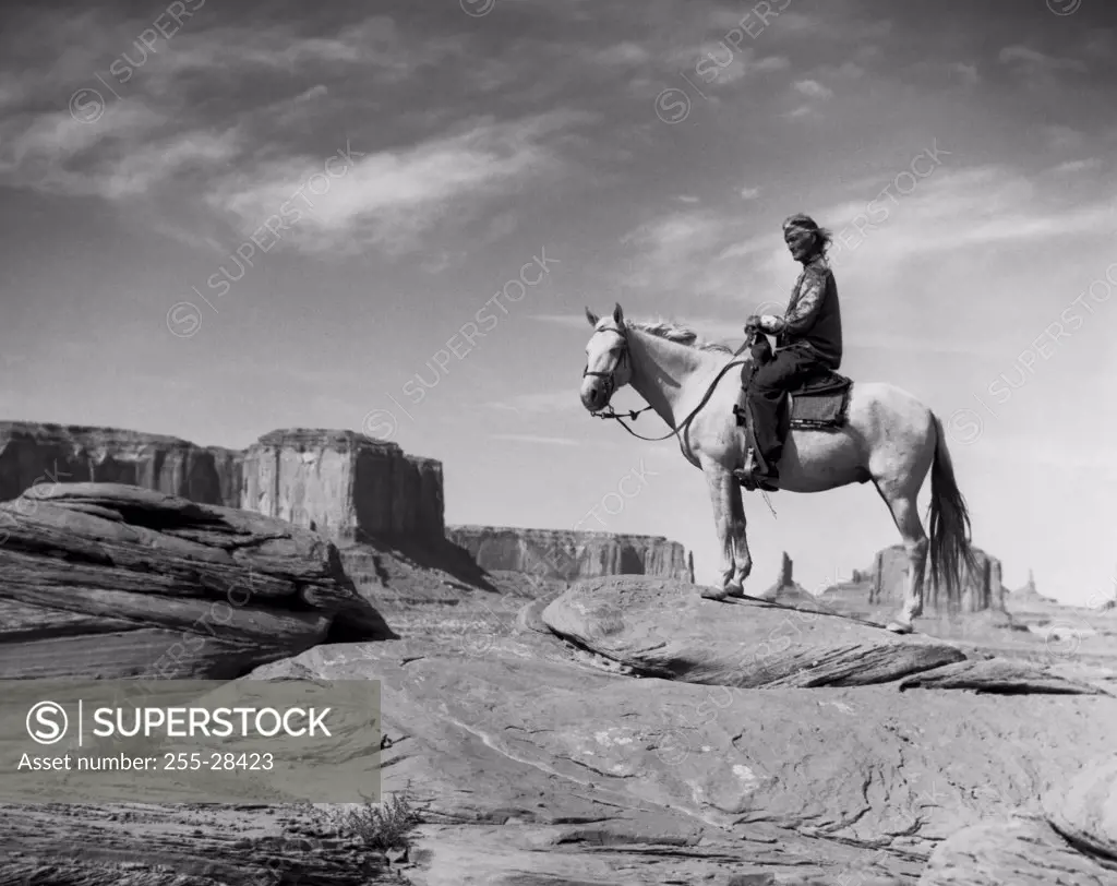 Navajo man riding a horse