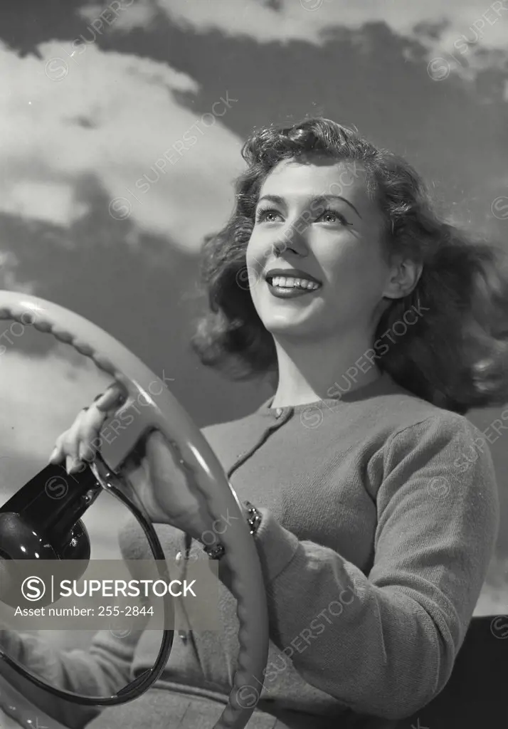 Vintage photograph. Woman driving car with hair down