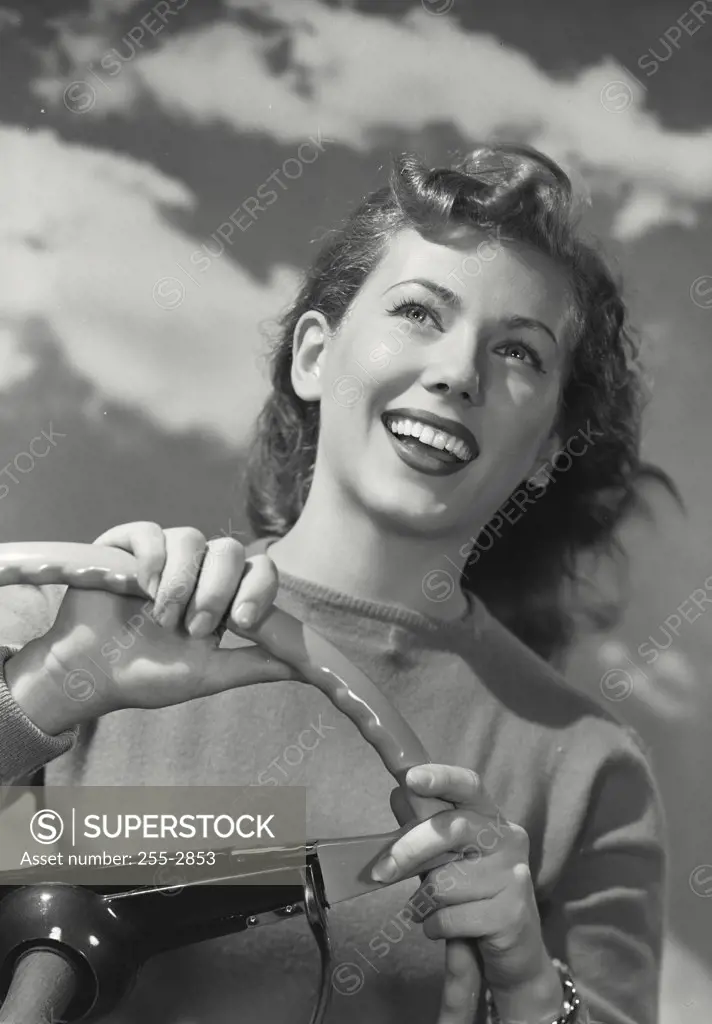 Vintage photograph. Woman driving car with smiling hair down