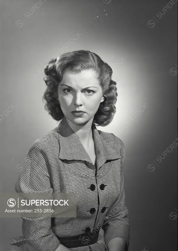 Vintage Photograph. Woman in coat looking at camera with concerned expression