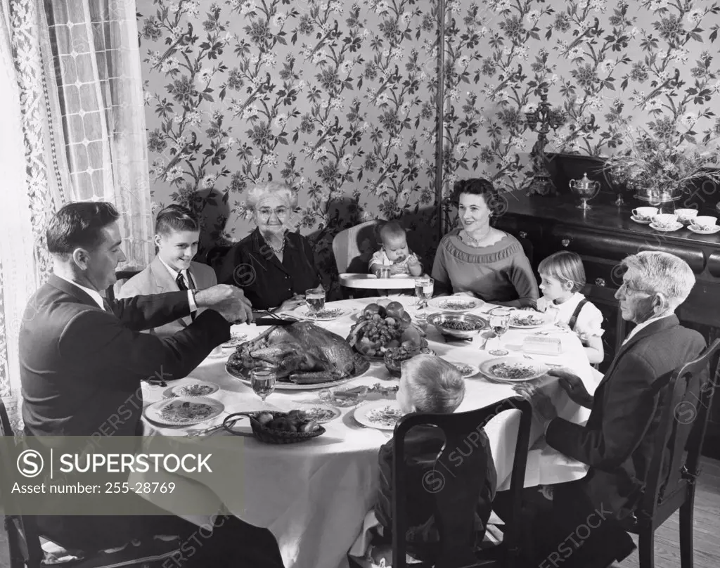 Family with children at dining table on Thanksgiving Day