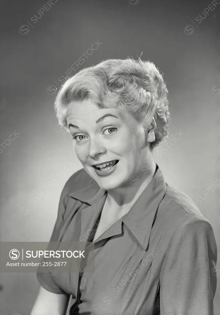 Vintage photograph. Portrait of woman in collared blouse smiling at camera