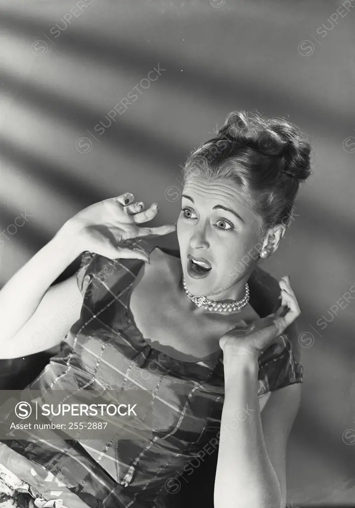 Vintage photograph. Close-up of a young woman looking frightened