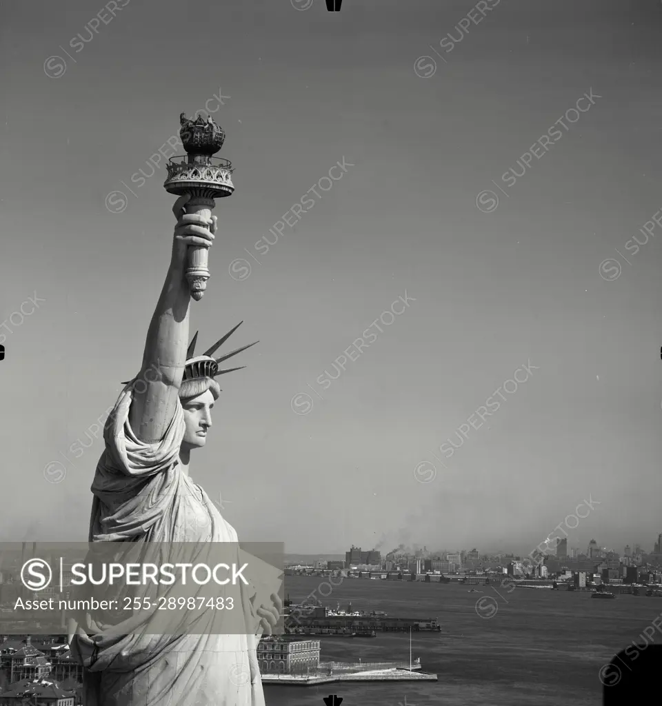 Vintage Photograph. Top half of Statue of Liberty and Lower Manhattan skyline in distance, New York City, Frame 6