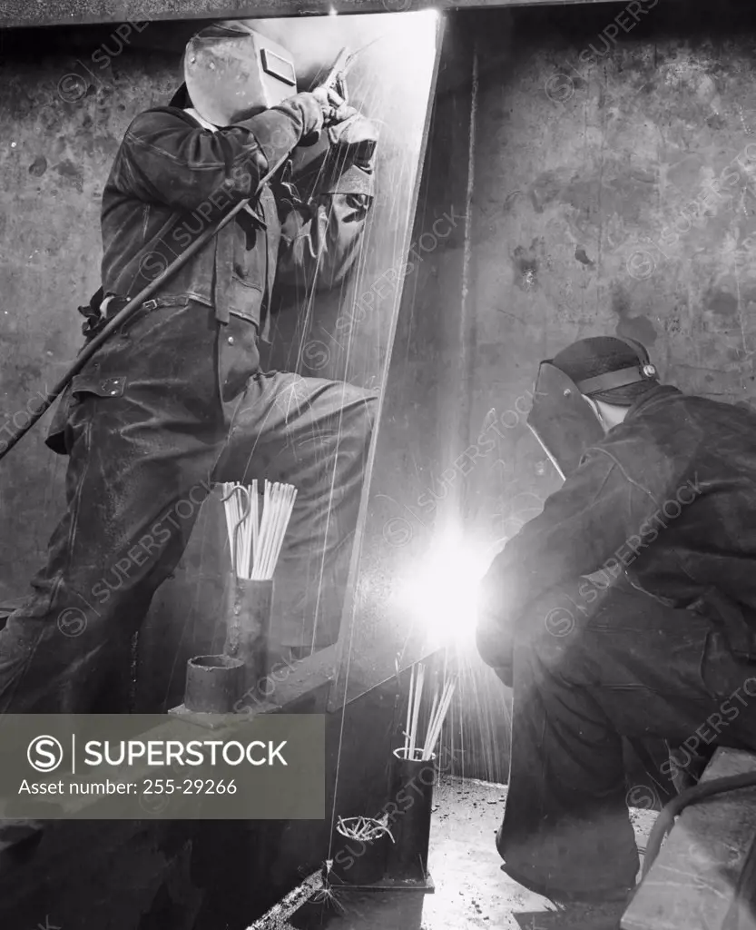 Two men welding