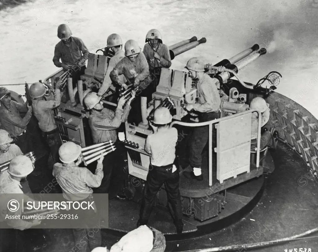 Vintage photograph. Anti aircraft gun crew aboard an Essex class Carrier of the 7th fleet test fire their weapons in Korean waters