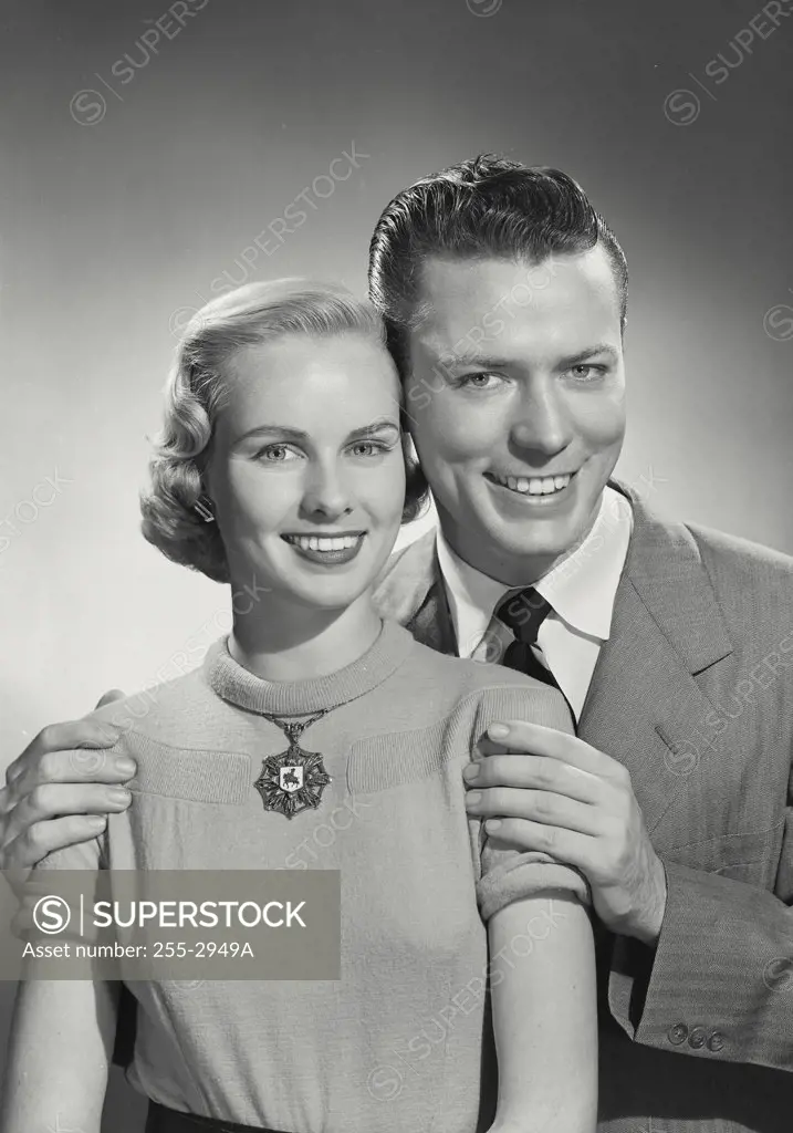 Vintage photograph. Portrait of man behind woman with hands on her shoulders