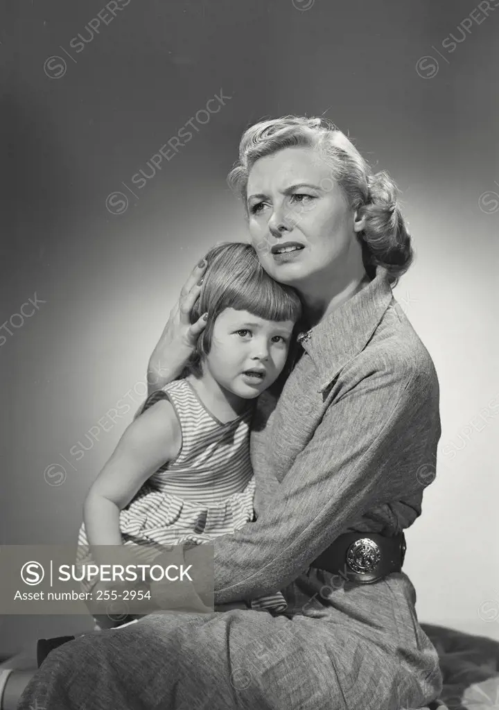 Vintage photograph. Woman and child holding each other looking fearful