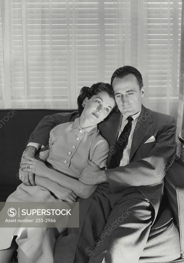 Vintage Photograph. Husband and wife sitting on couch together. Frame 1