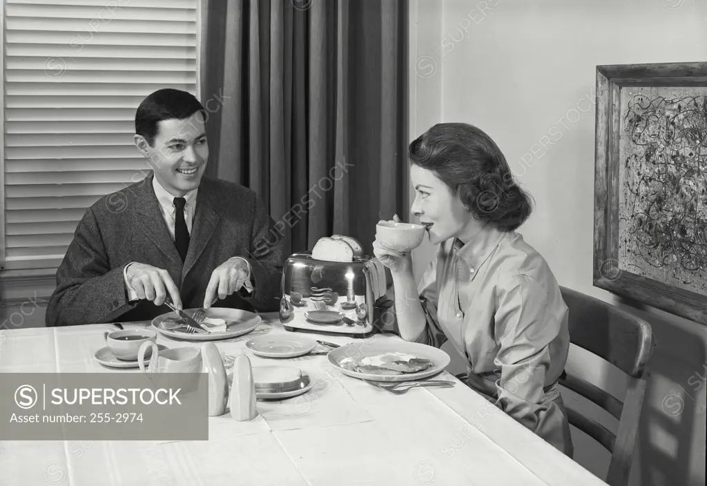 Vintage Photograph. Husband and wife eating breakfast together.