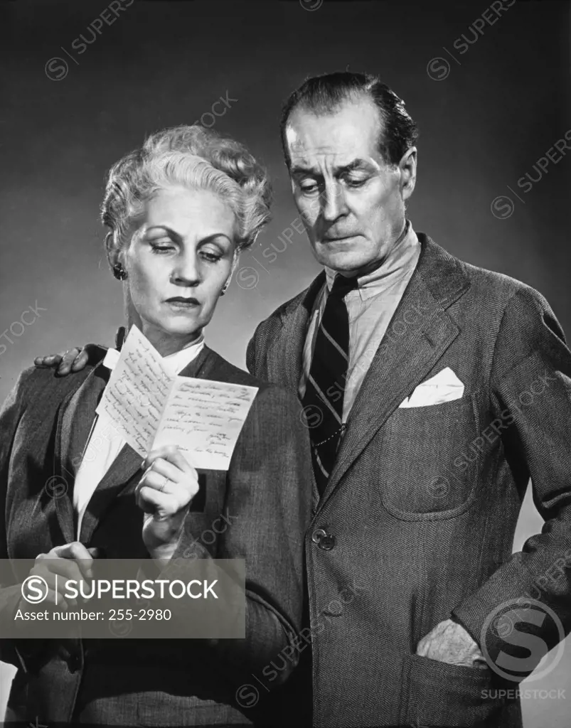 Close-up of a senior couple reading a letter