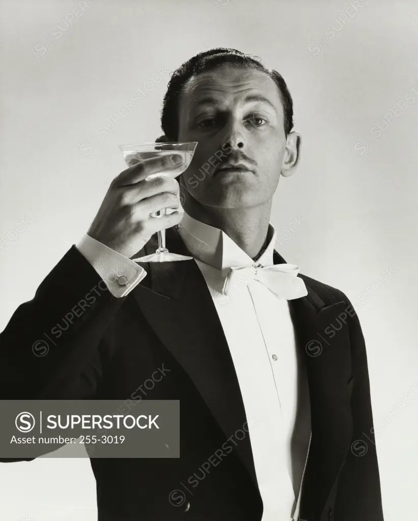 Portrait of a mid adult man holding an alcoholic beverage