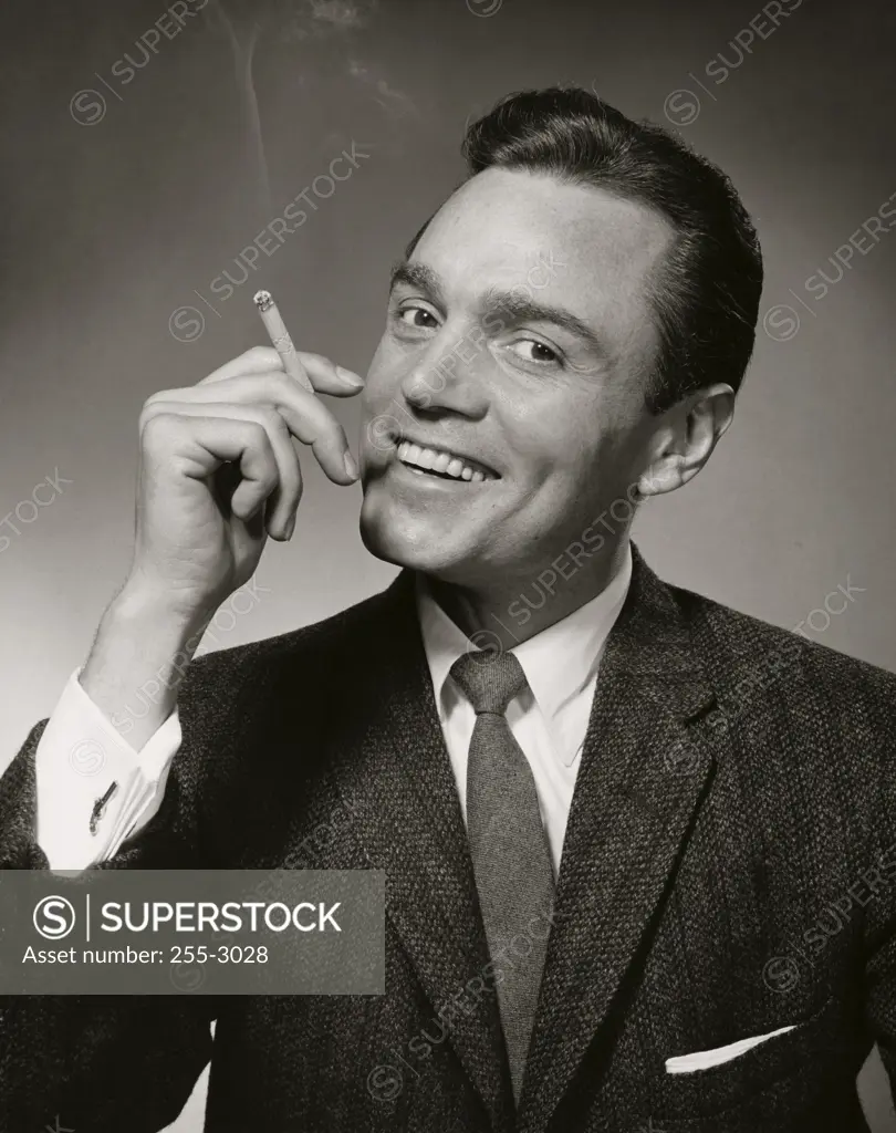 Portrait of a mid adult man smoking a cigarette
