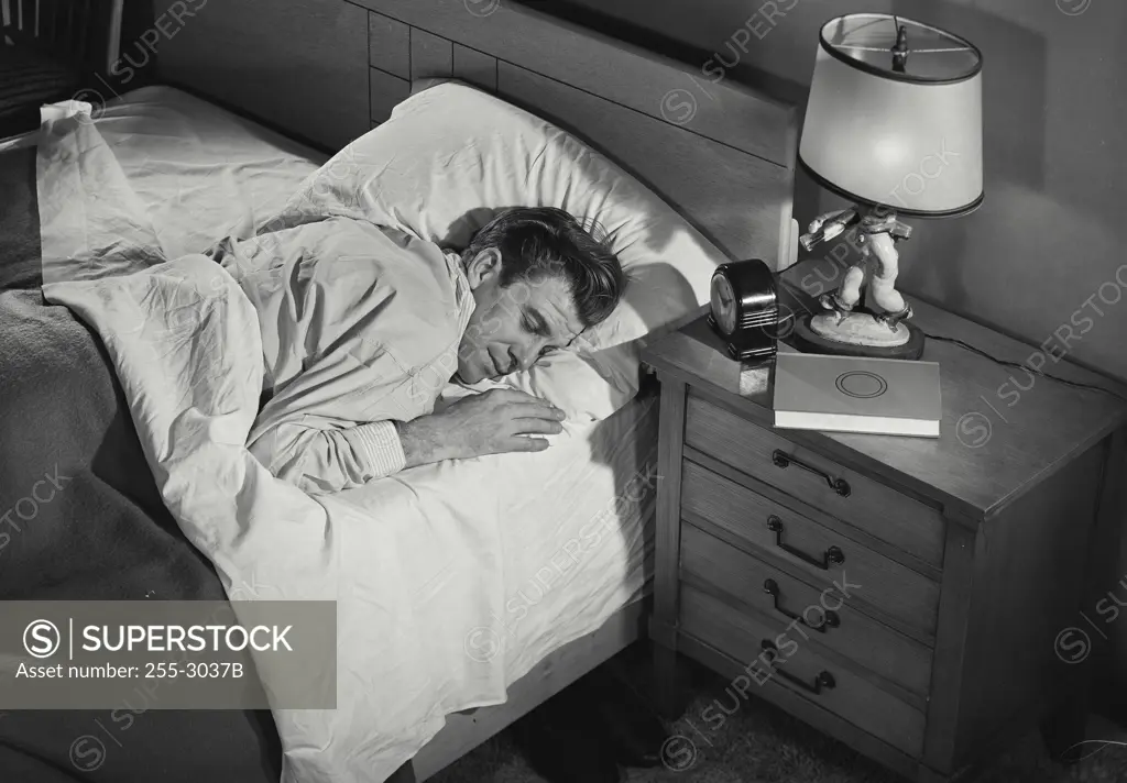 Vintage Photograph. Man in pajamas asleep in bed. Frame 1