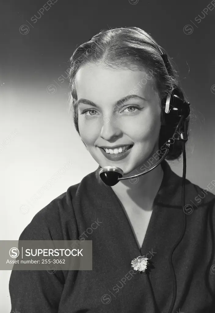 Vintage photograph. Woman smiling and talking on headset.
