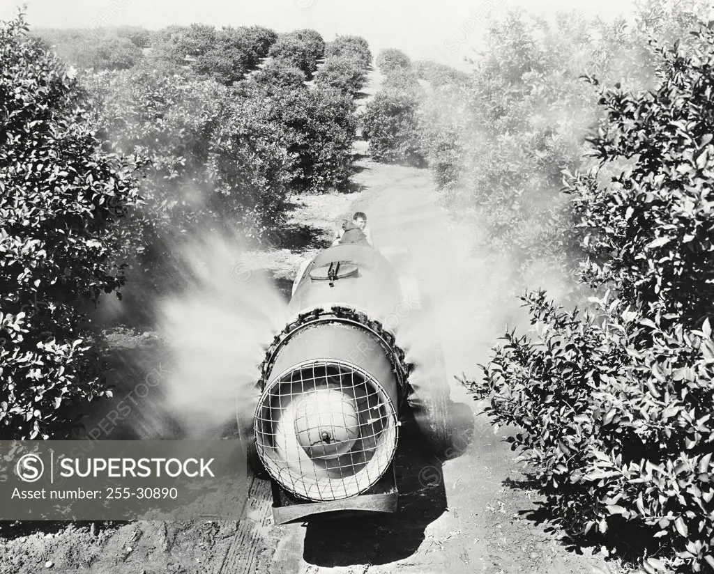 Vintage photograph. Cat D2 tractor pulls a 500 gallon John Bean speed sprayer