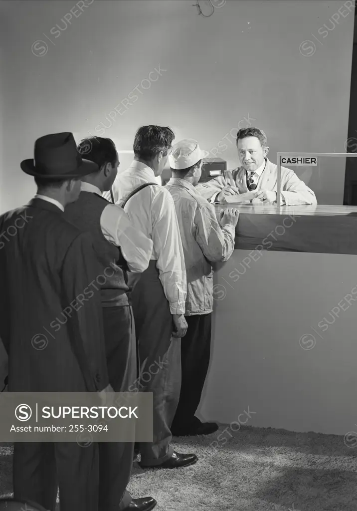 Vintage Photograph. Men standing in the line waiting for the cashier.