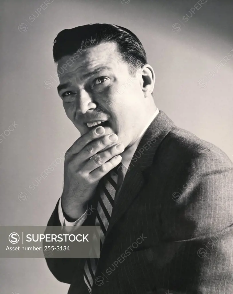 Side profile of a businessman thinking with his hand on his chin