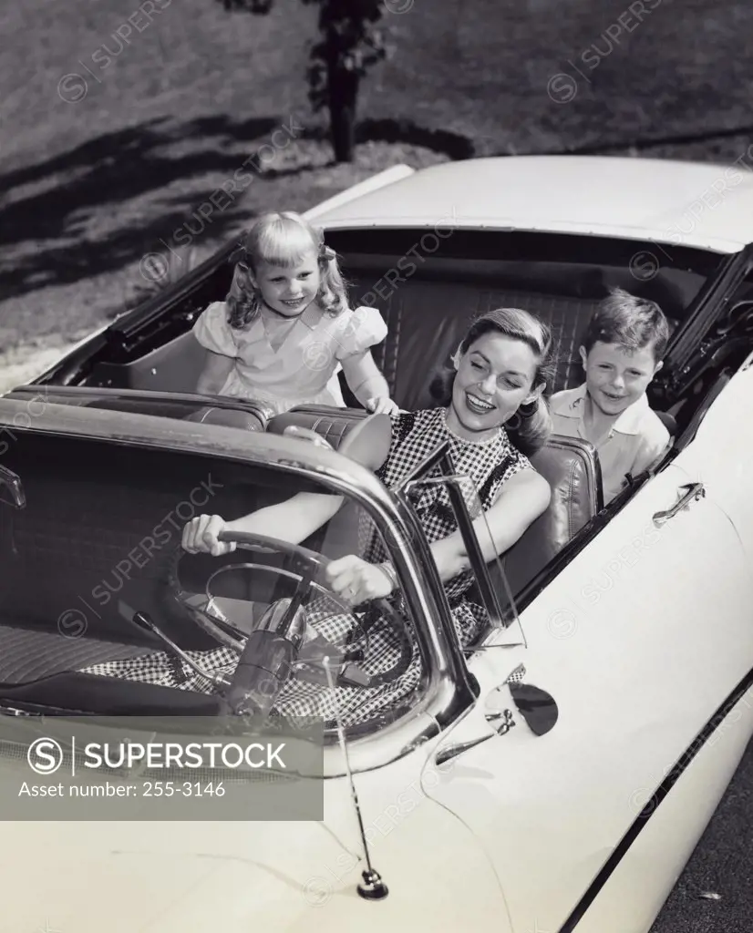 Mother and children sitting in car