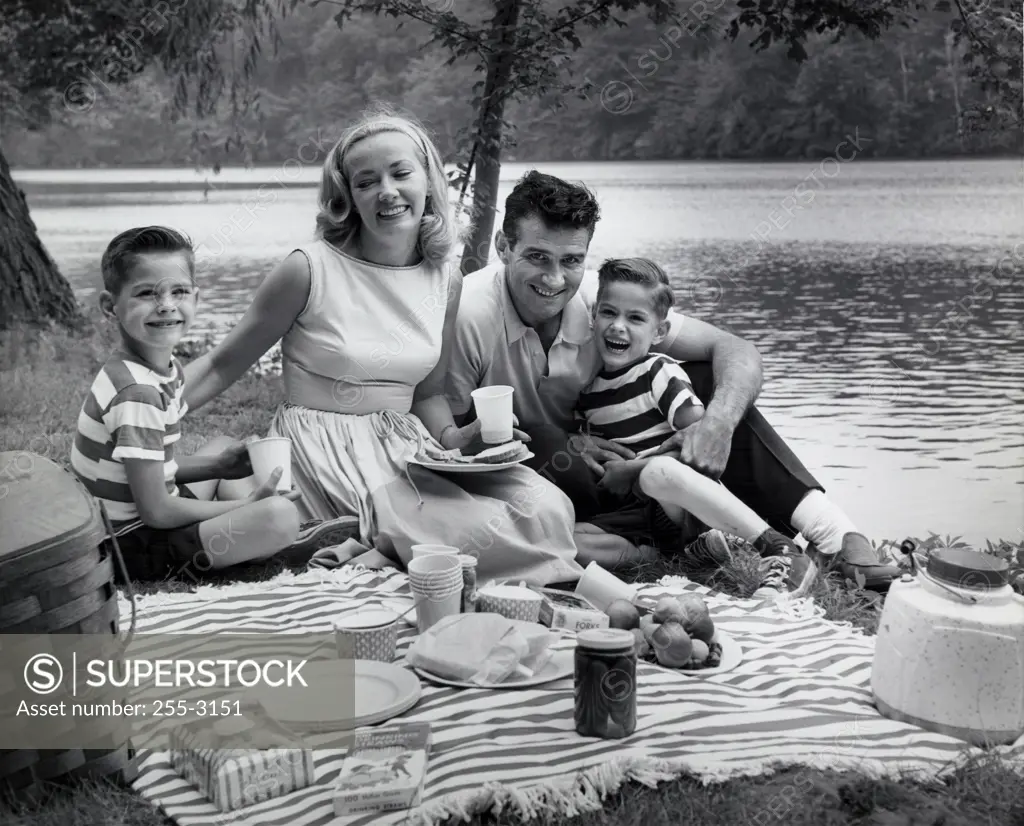 Portrait of a family at a picnic near a lake