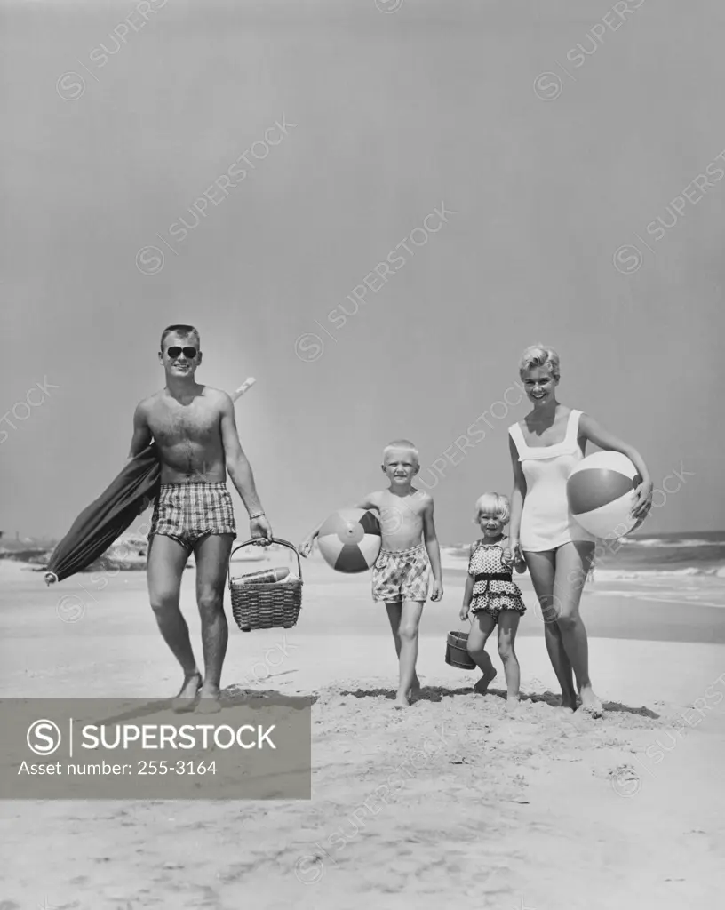 Parents with two children walking on beach