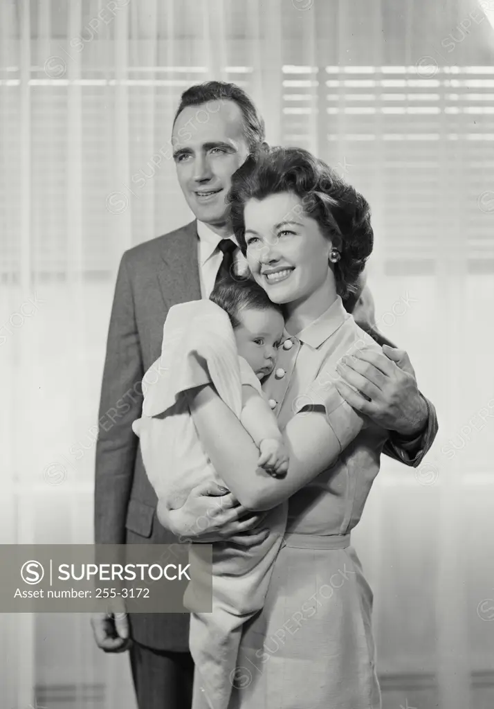 Vintage Photograph. Parents holding small baby in arms. Frame 4