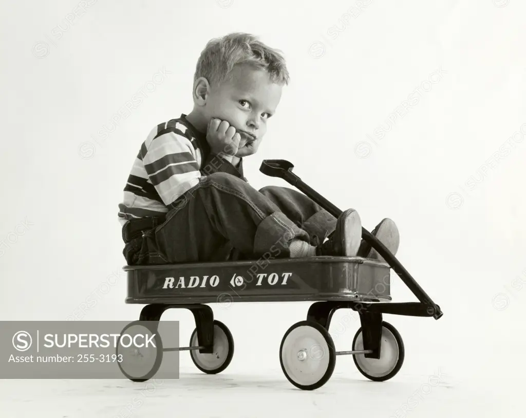 Portrait of a boy sitting in a wagon