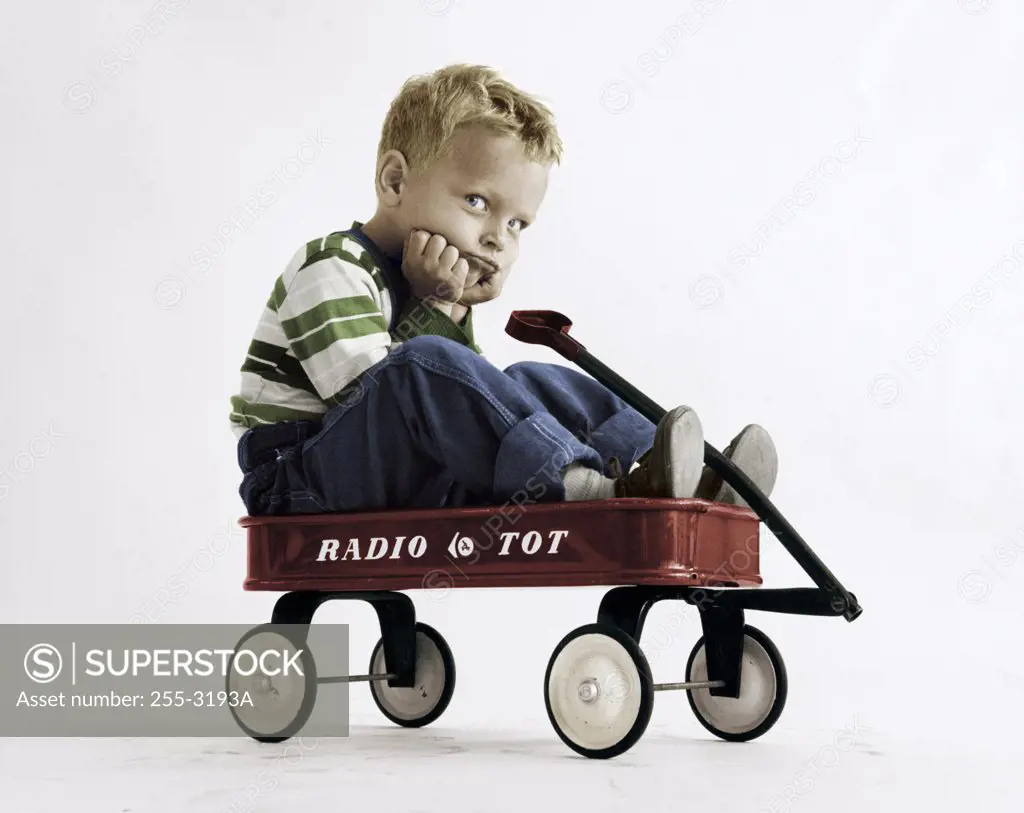Portrait of boy sitting in wagon