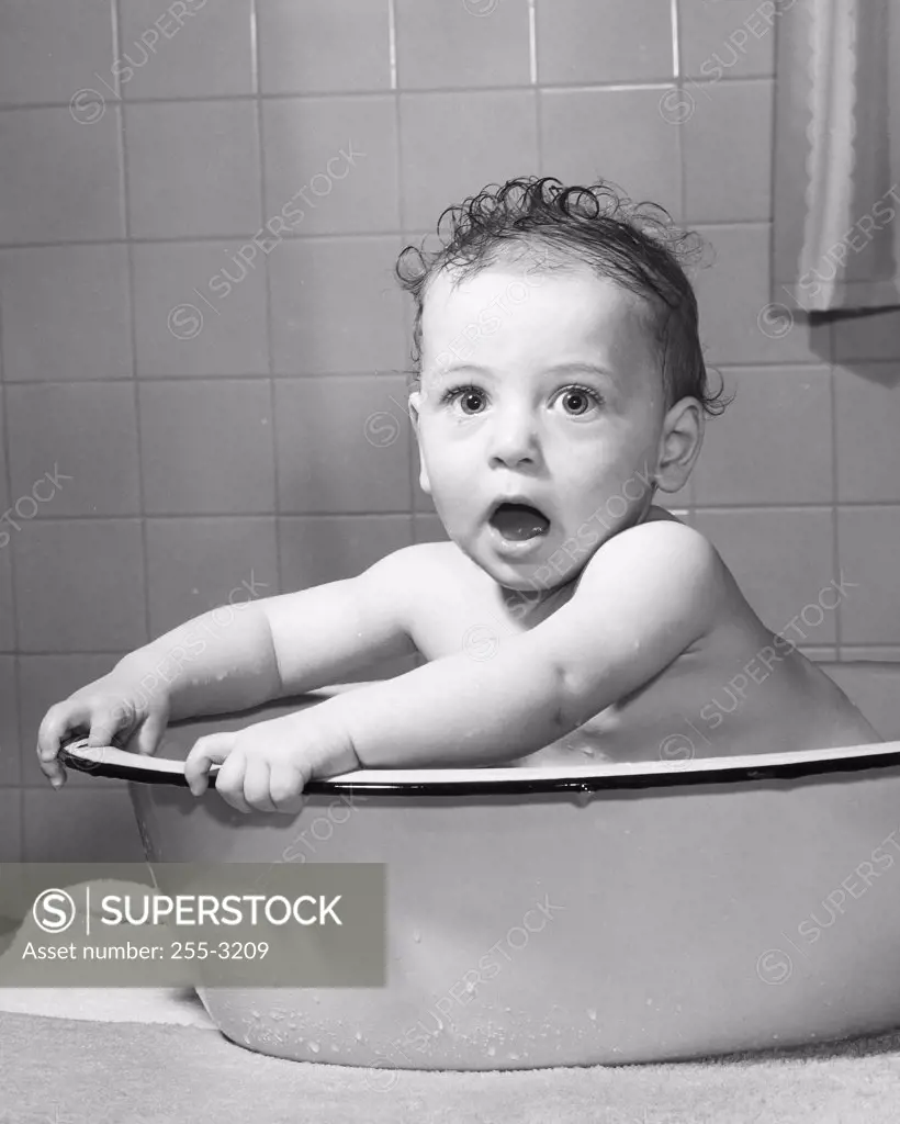 Portrait of a baby boy sitting in a bathtub
