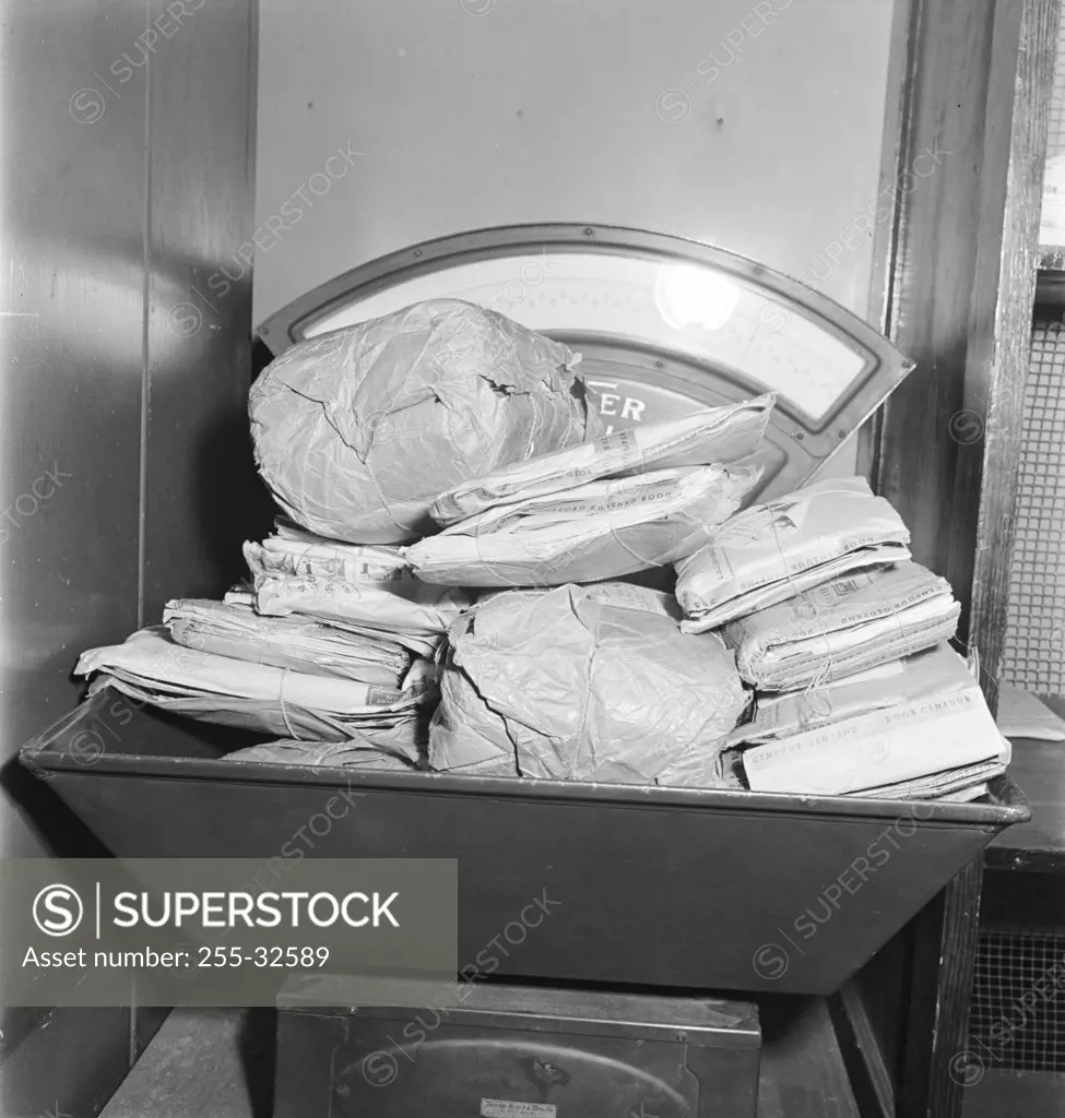 Vintage photograph. Weighing foreign parcel post packages at US Post Officep