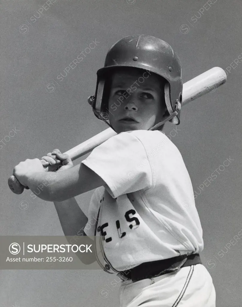 Close-up of a youth league baseball player holding a baseball bat