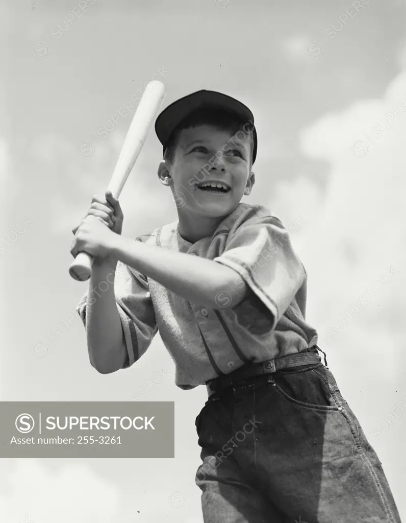 Vintage photograph. Young boy with baseball bat waiting for pitch
