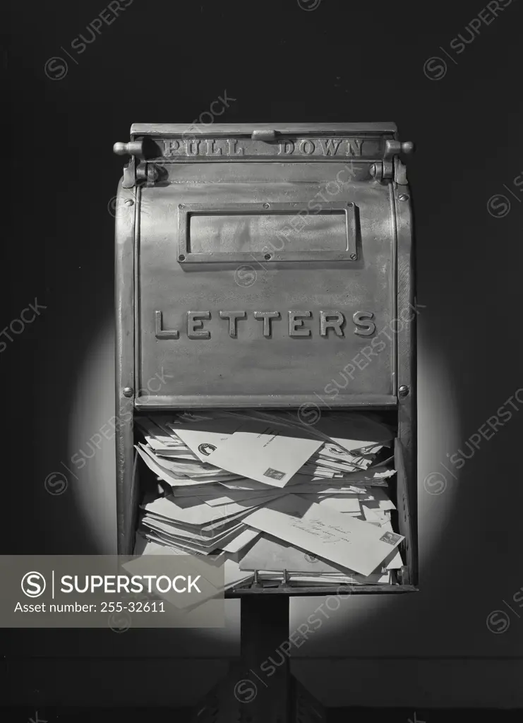 Vintage Photograph. Front of US Mail Letter box with bottom door open full of envelopes