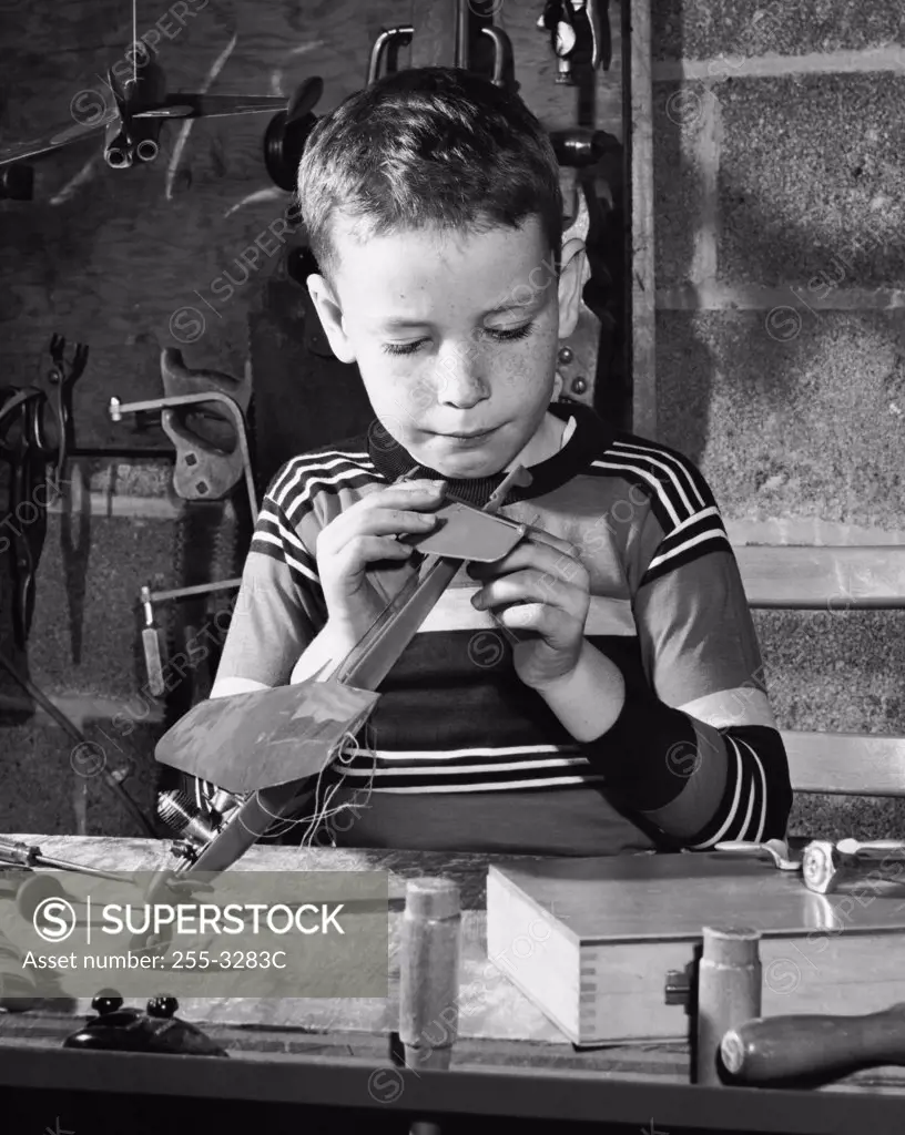 Boy repairing a model airplane
