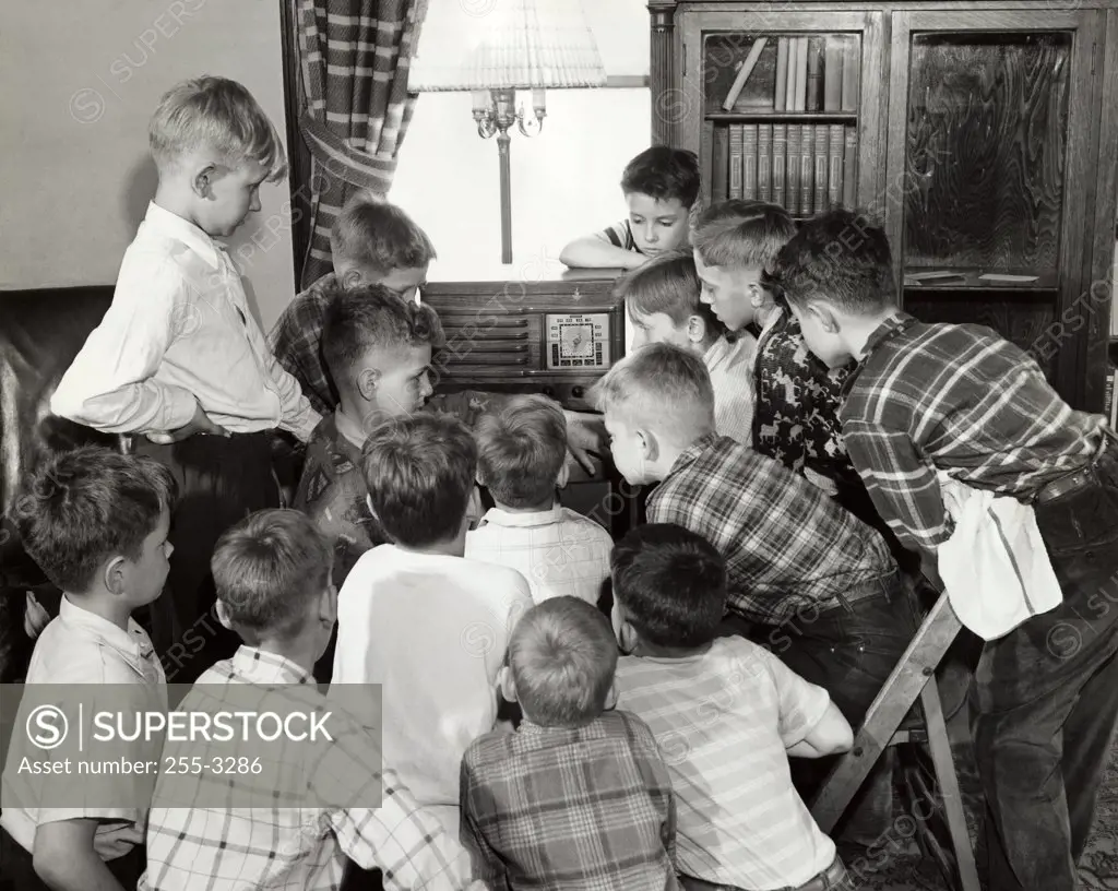 Group of boys listening to the radio